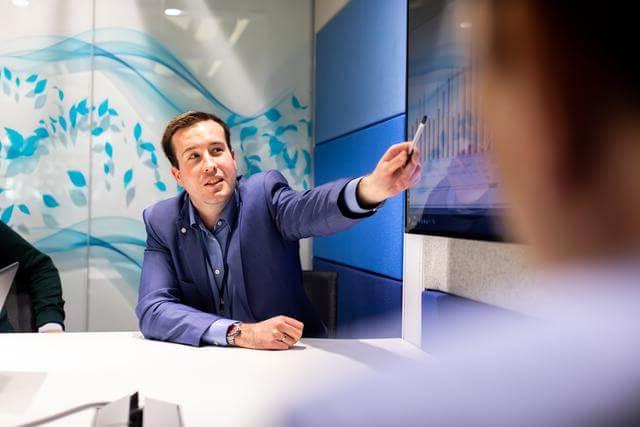 Professional man pointing at a presentation in an office